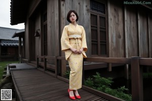 A naked asian woman sitting on a wooden floor.