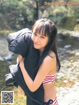 A young woman in a school uniform posing for a picture.