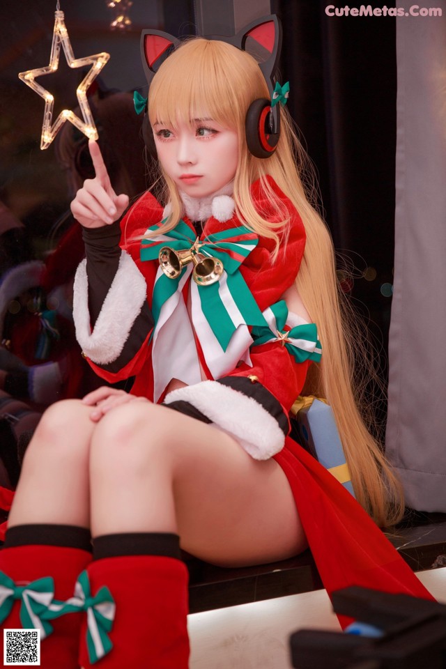 A woman in a red and white outfit holding a star.