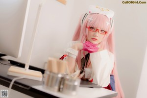 A woman dressed as a nurse sitting on a chair.