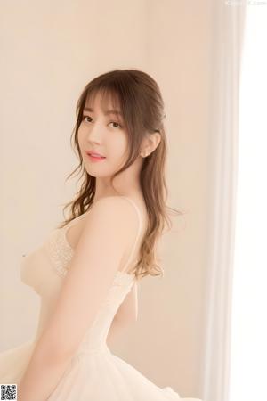 A woman in a white dress posing for a picture.