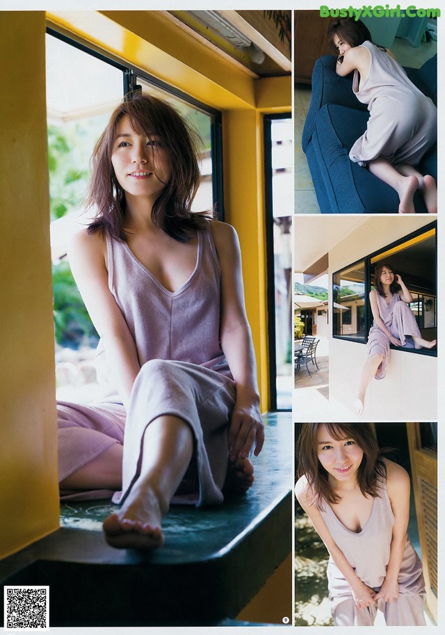 A woman sitting on a window sill in a pink dress.