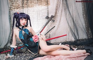 A woman with long purple hair sitting on a table.