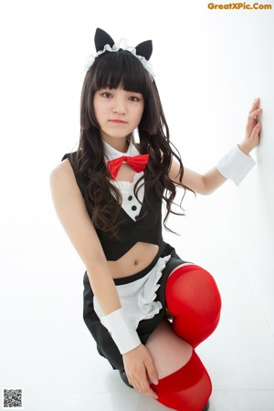 A woman in a black and white outfit and red stockings.