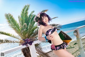 A woman in a bikini standing in the water.