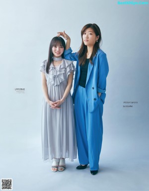 A woman in a blue suit sitting next to another woman.