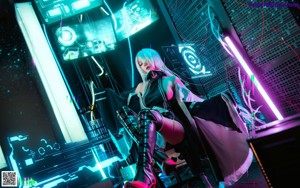 A woman with long white hair sitting in front of a neon sign.